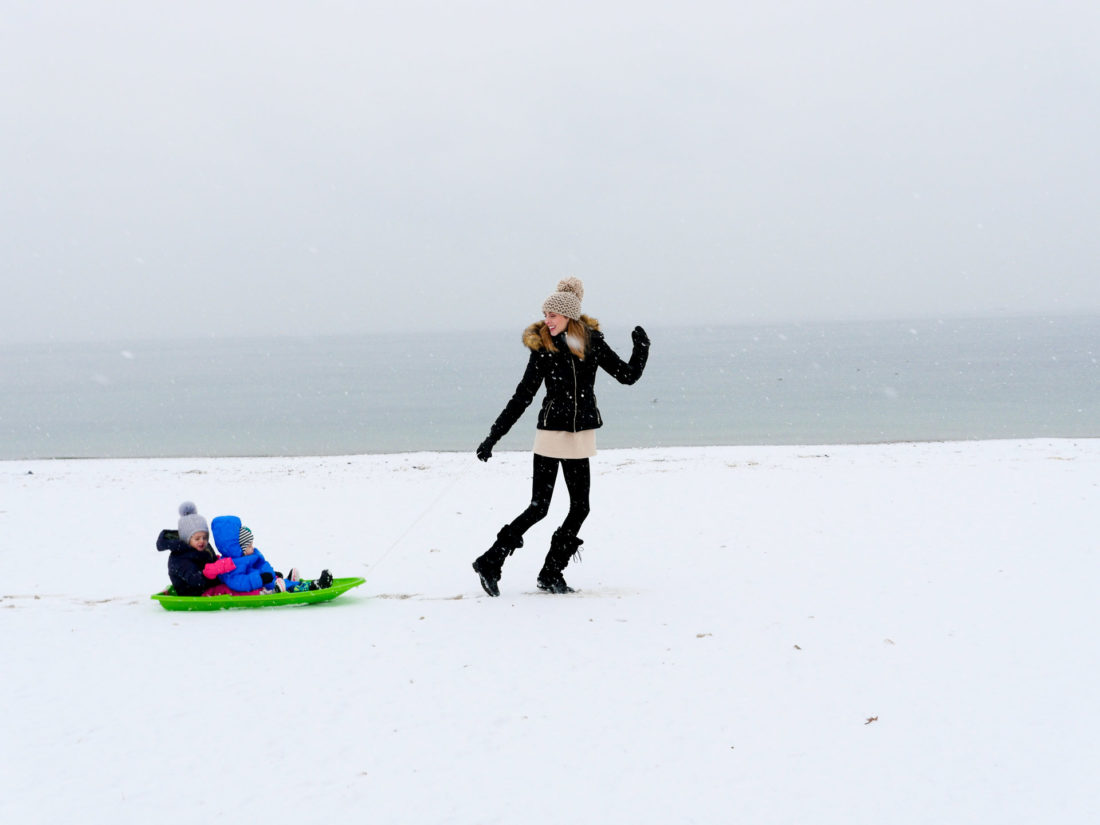 Eva Amurri Martino pulls her children through the snow on the beach in Westport, CT