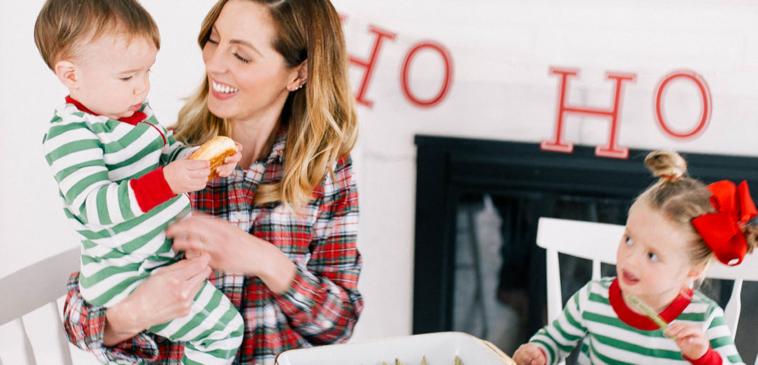 Eva Amurri Martino sits with children marlowe and major around the kitchen table decorated for Christmas brunch