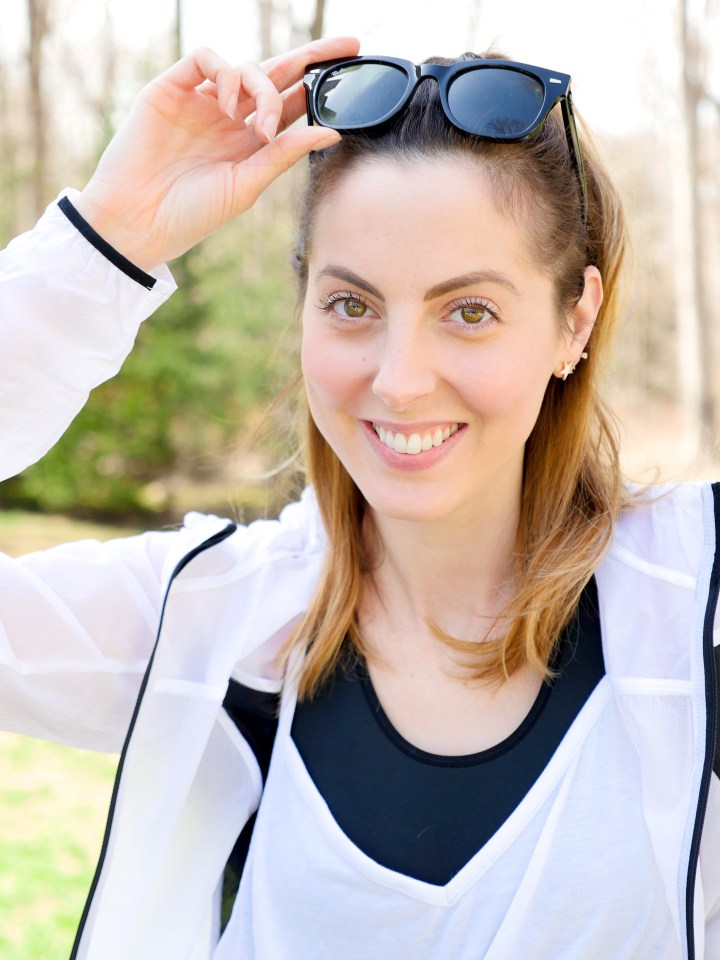 Eva Amurri martino wears black and white polka dot workout pants, a white windbreaker, and Ray Ban sunglasses as she heads off for a workout in Connecticut