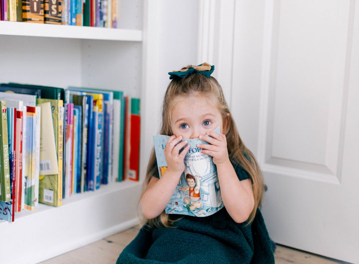 Marlowe Martino hides behind a book in the kitchen of her Connecticut home