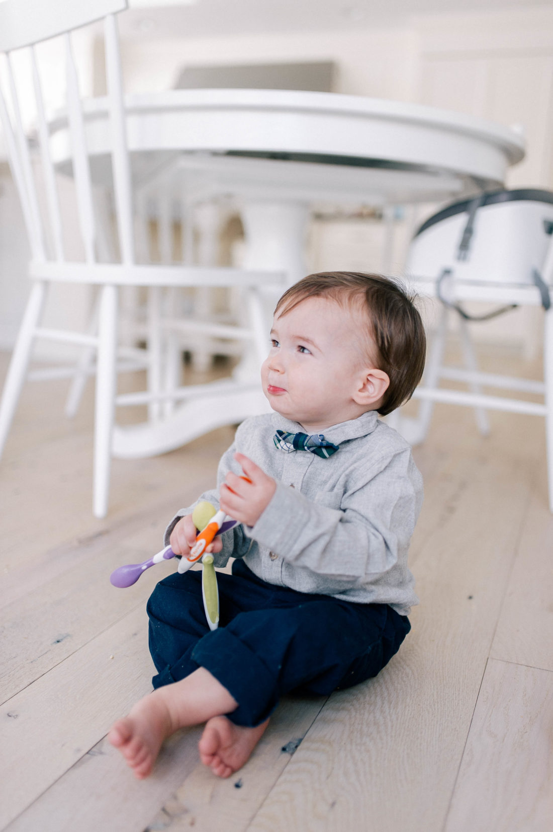 Major Martino sits on the hardwood kitchen floor in his Connecticut home and holds toddler feeding spoons