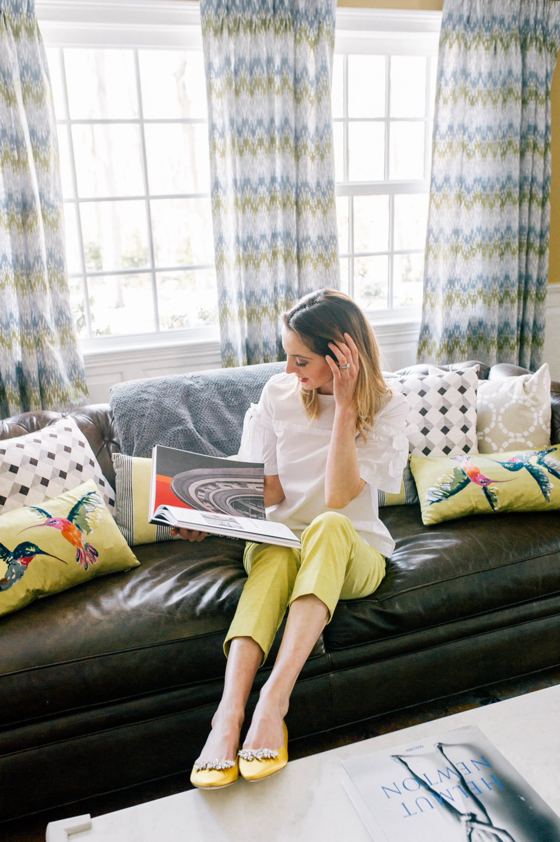 Eva Amurri Martino wears a pair of canary yellow manolo blahnik flats in the formal living room of her Connecticut home