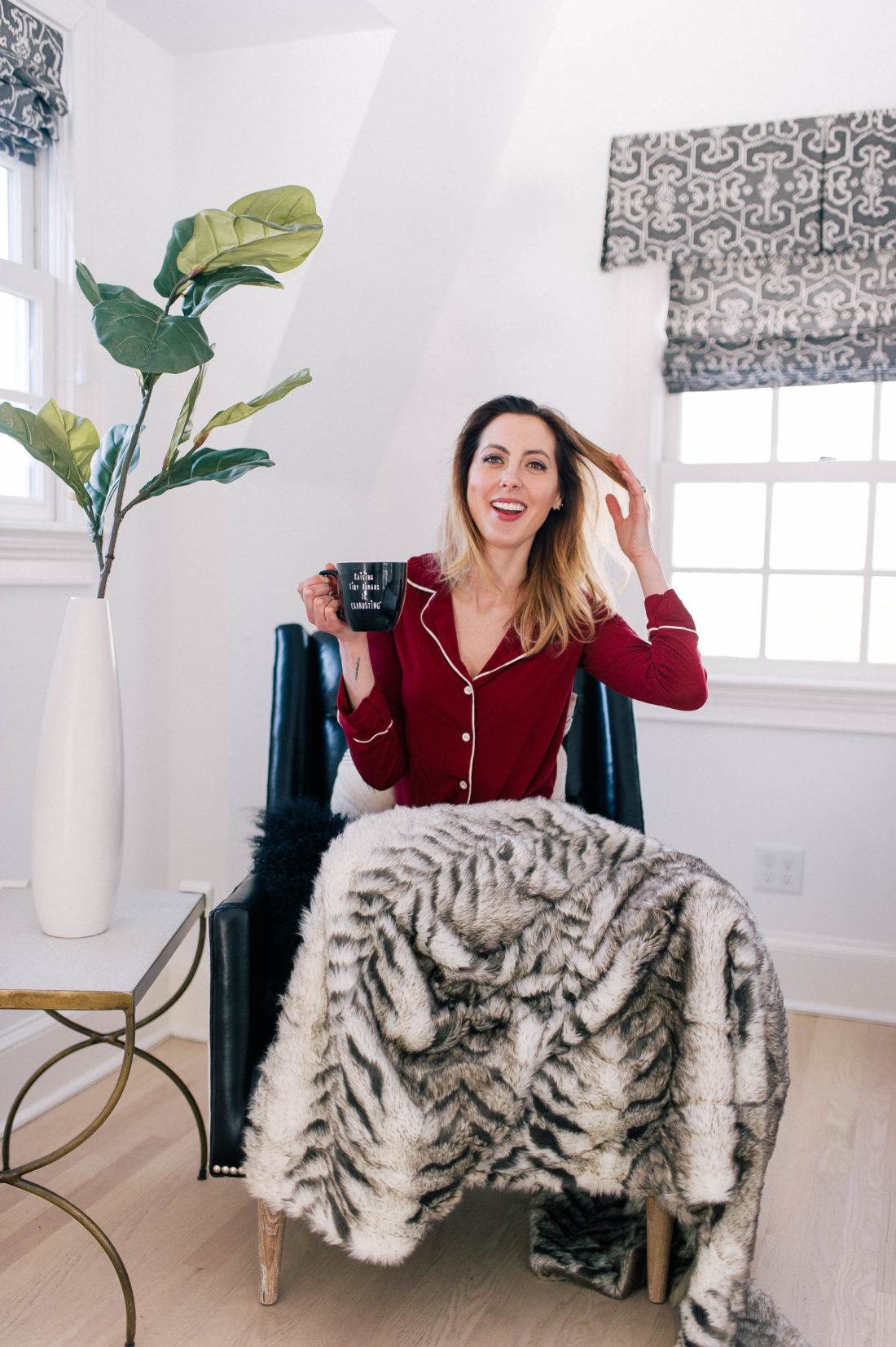 Eva Amurri Martino cozies up in her leather armchair with a fur blanket and a pair of cozy pajamas, holding a cup of tea