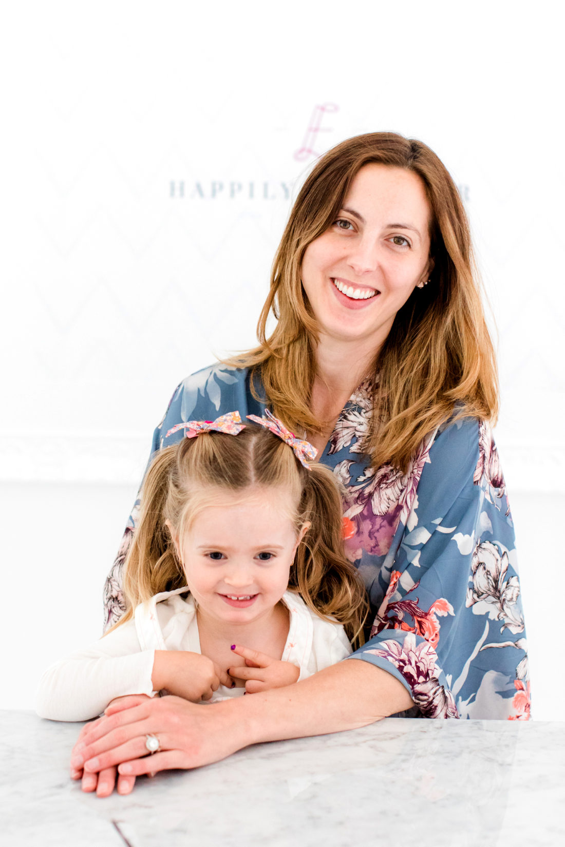 Eva Amurri martino sits with daughter, Marlowe, as she prepares to apply her makeup for a blog photo shoot