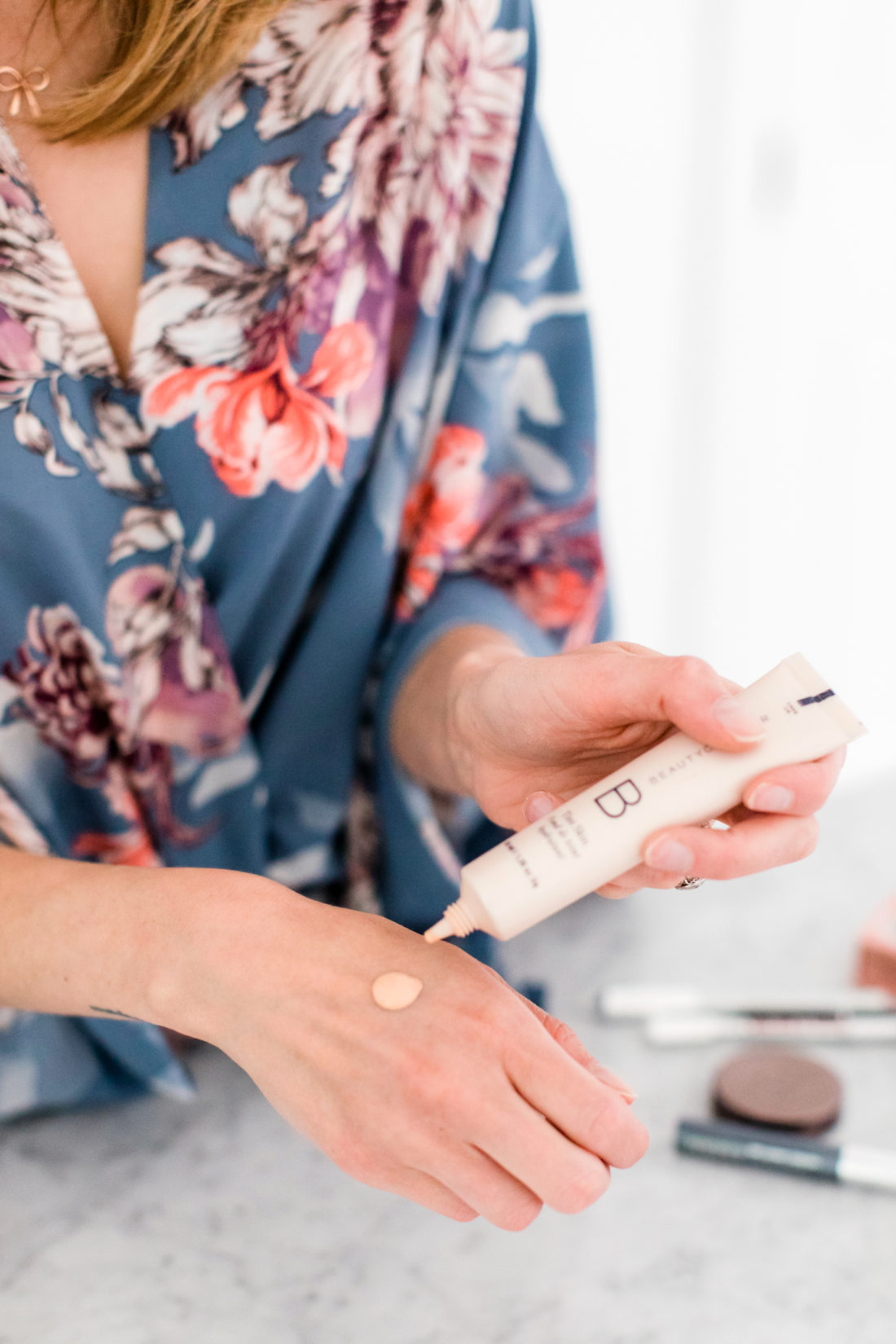 Eva Amurri martino applies a lightweight foundation as part of her photo shoot makeup tutorial