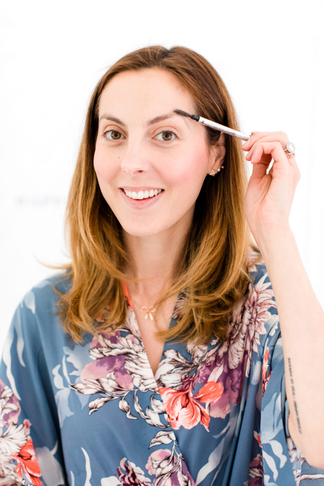 Eva Amurri Martino brushes her brows before applying brow pencil