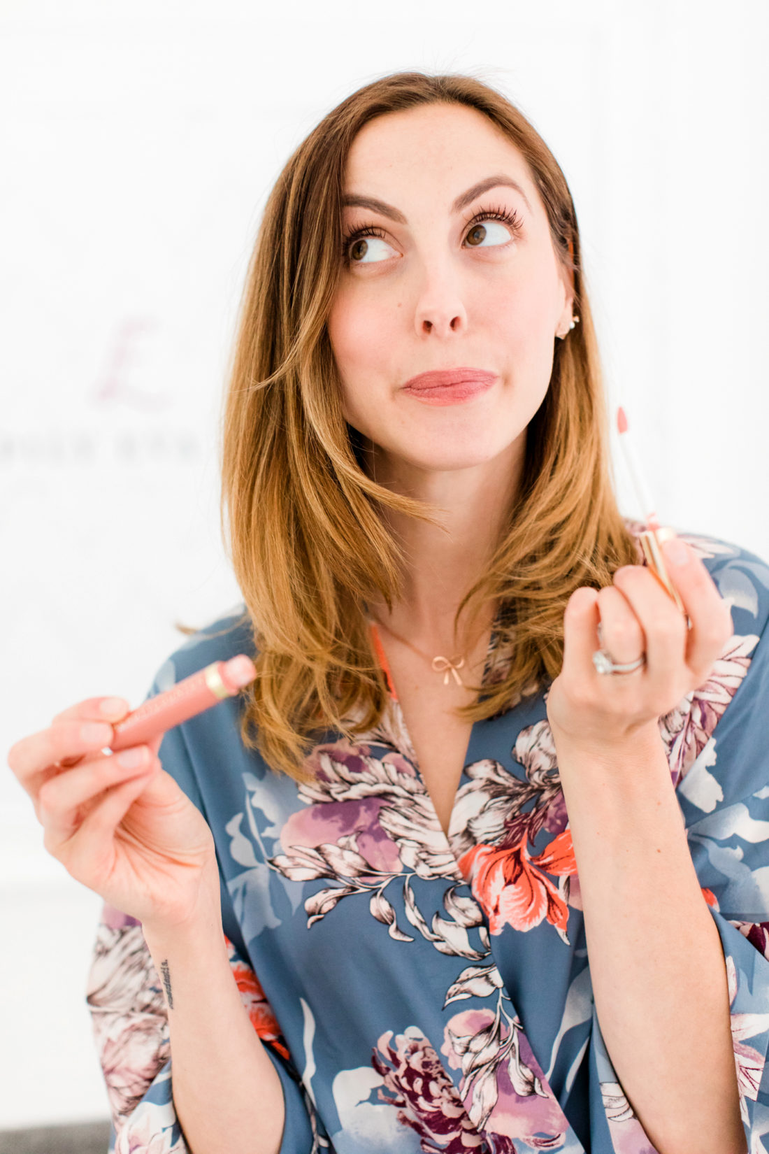 Eva Amurri Martino applies lip gloss to her lips