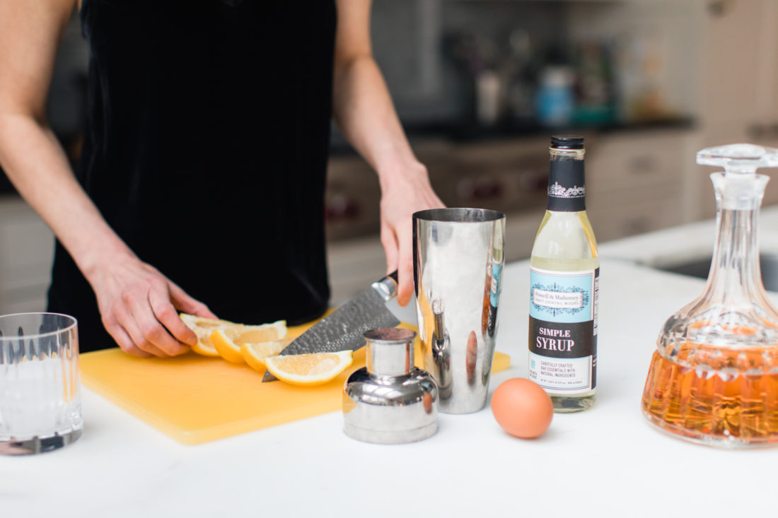 Eva Amurri Martino cuts a lemon as preparation for a whiskey sour