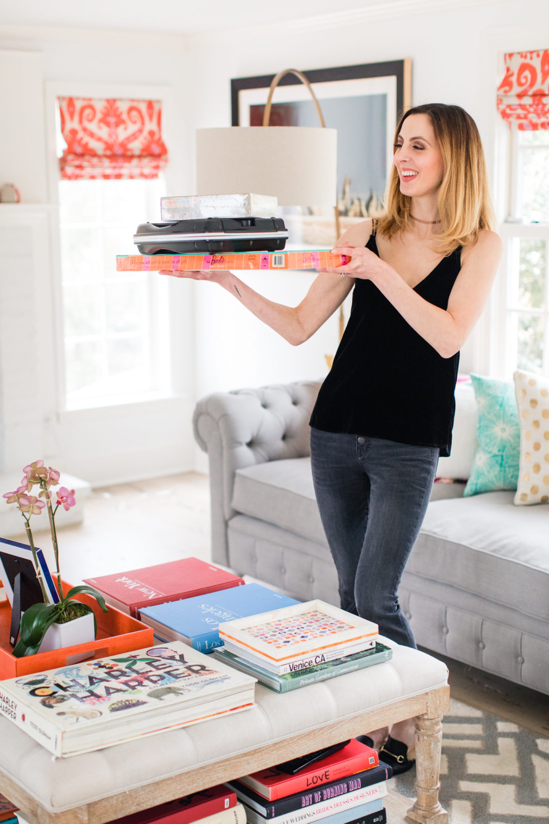 Eva Amurri Martino carries a selection of board games in to the family room to set up for a date night at home