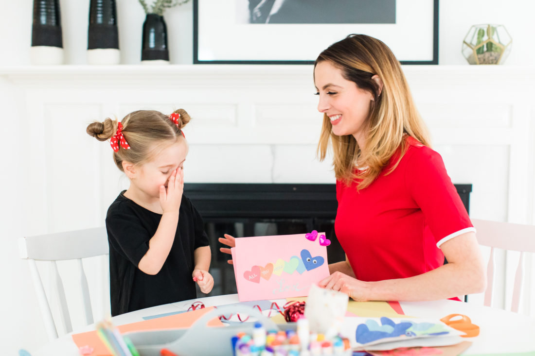 Marlowe Martino wipes off her Mom's kisses while they make homemade Valentine's Day cards together