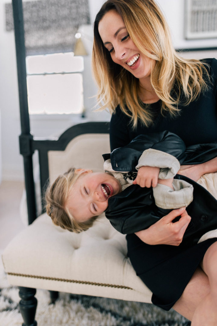 Marlowe Mae Martino getting ticked by her mother, Eva Amurri Martino, wearing a leather jacket and a halo braid in her hair.