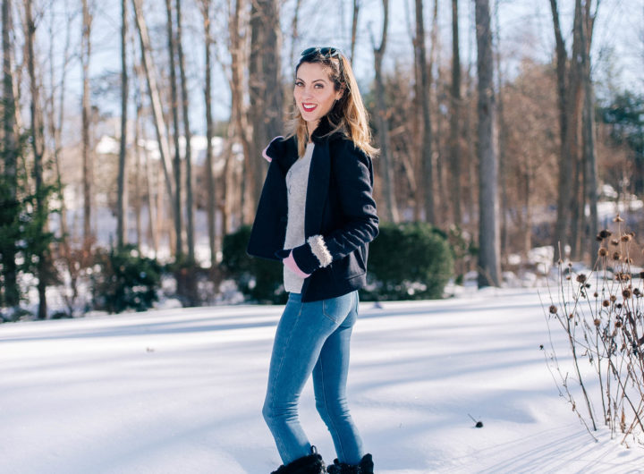 Eva Amurri Martino stands in the snow outside her Connecticut home wearing blue jeans, a sweater, navy pea coat, and black snow boots