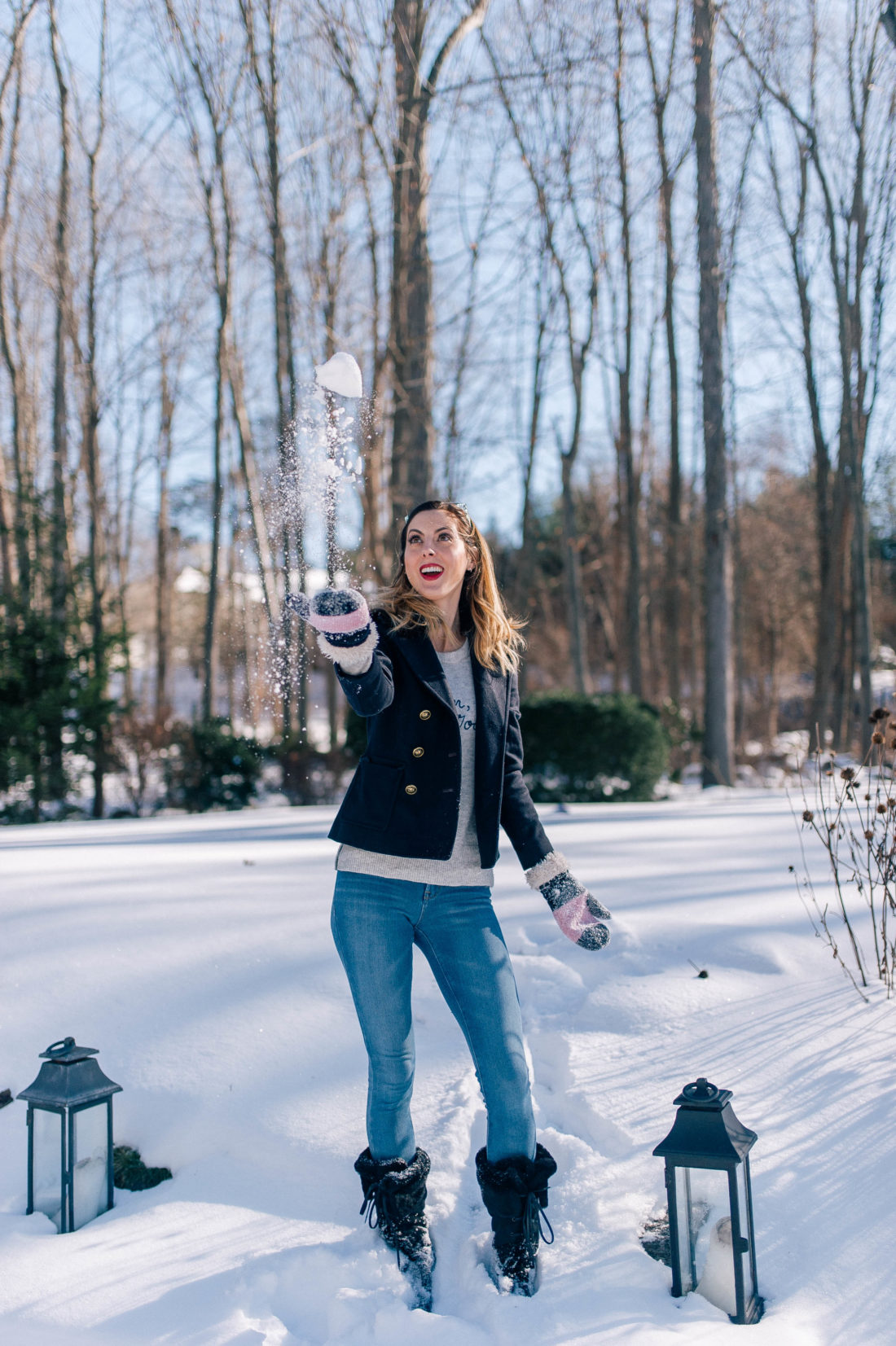 Eva Amurri Martino throws a snowball in to the air in the snowy yard outside her Connecticut home