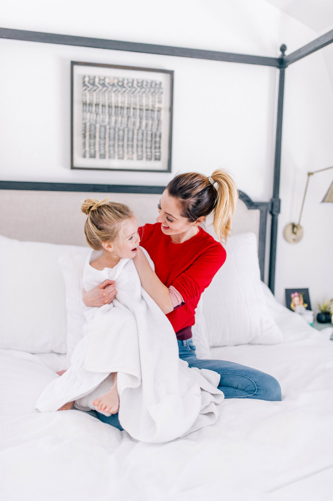 Eva Amurri Martino wraps daughter Marlowe in a white towel in the bedroom of her Connecticut home