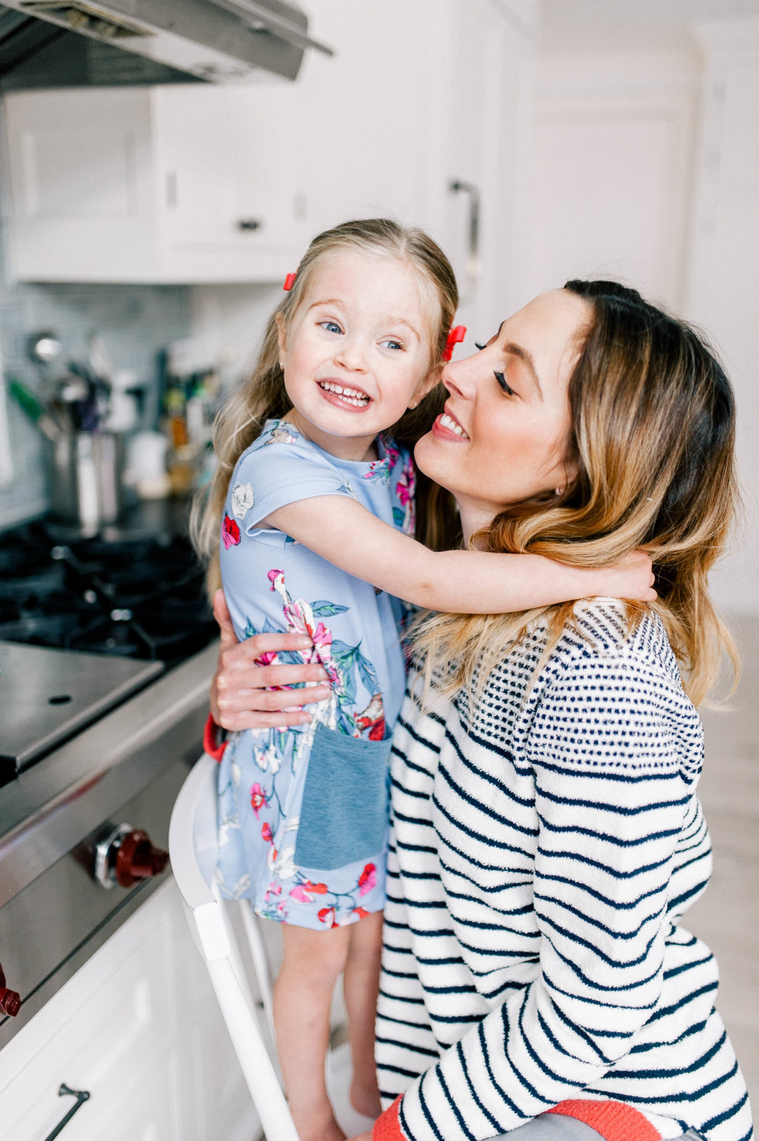 Marlowe Martino laughs and hugs mom Eva Amurri Martino while cooking in the kitchen of their Connecitcut home
