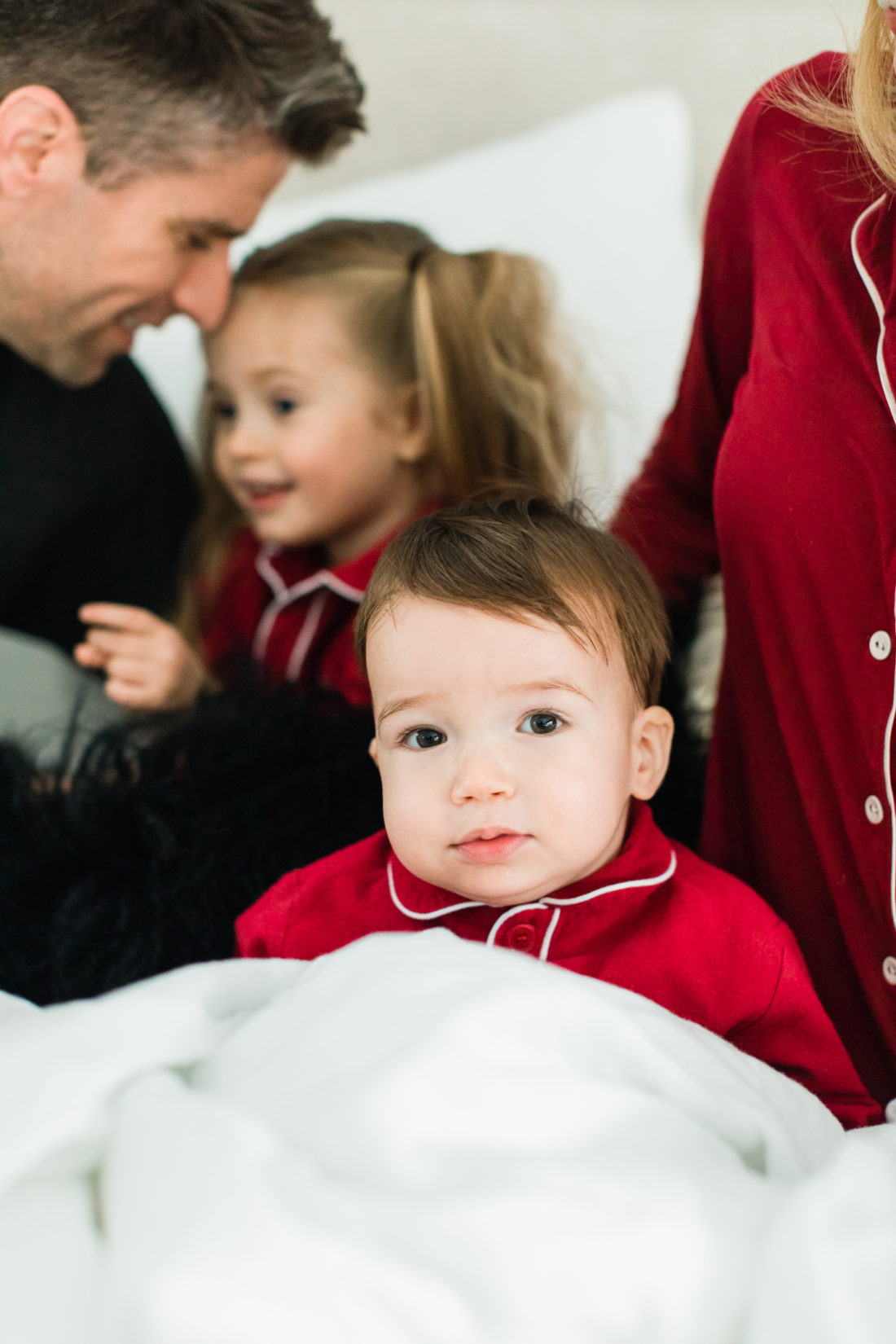 Major Martino wears red pajamas in bed with his parents on Valentine's Day