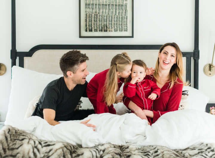 Eva Amurri martino, Kyle Martino, and children Marlowe and Major Martino cuddle in bed wearing red pajamas for Valentine's Day in the master bedroom of their Connecticut home