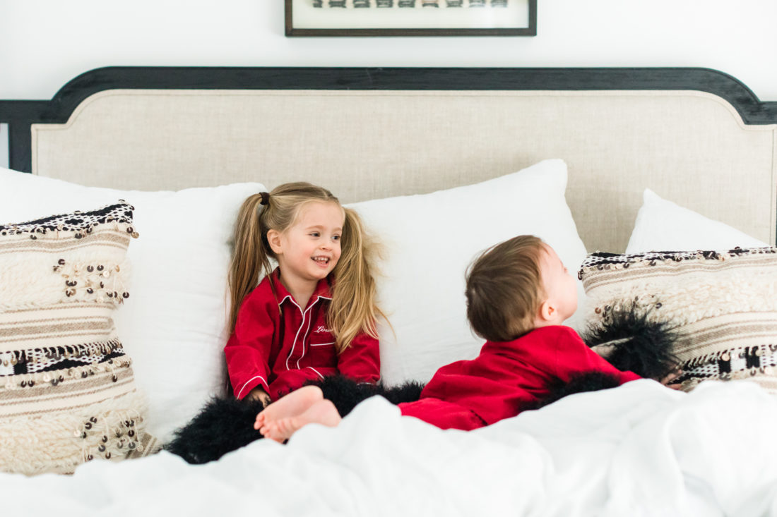 Marlowe Martino laughs and wrestles with little brother Major in the master bedroom of their Connecticut home