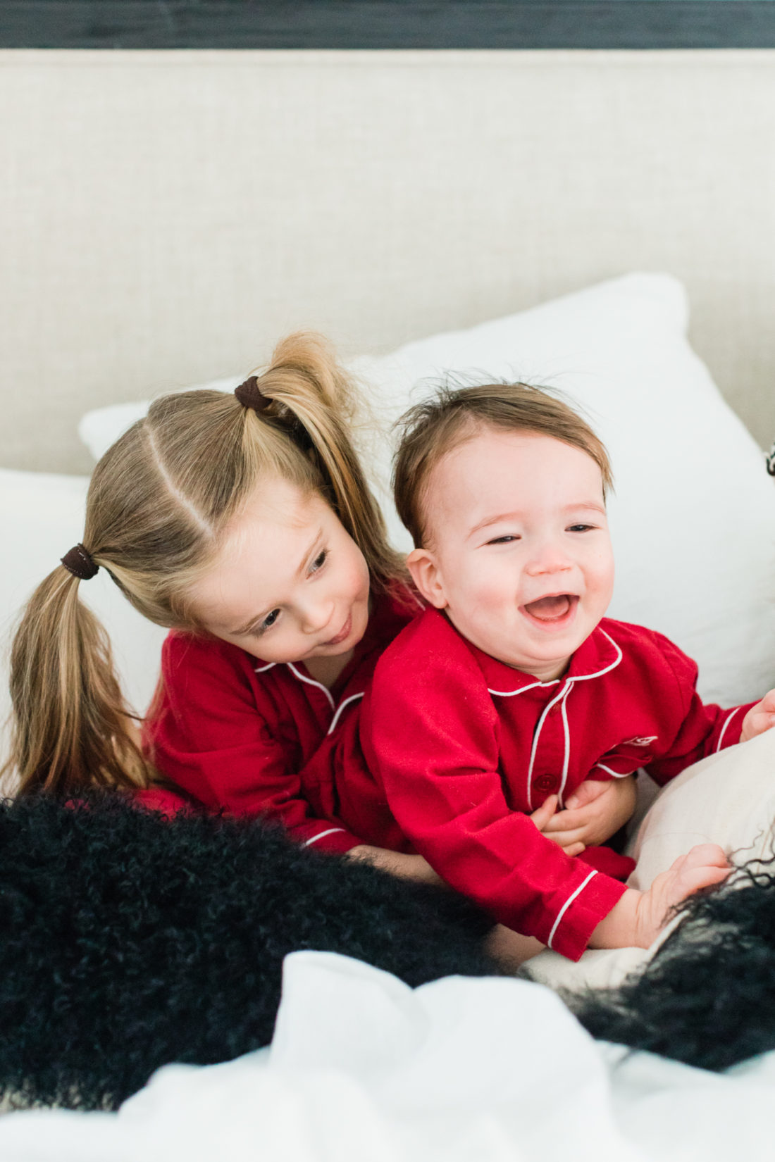 Marlowe Martino laughs and wrestles with little brother Major in the master bedroom of their Connecticut home