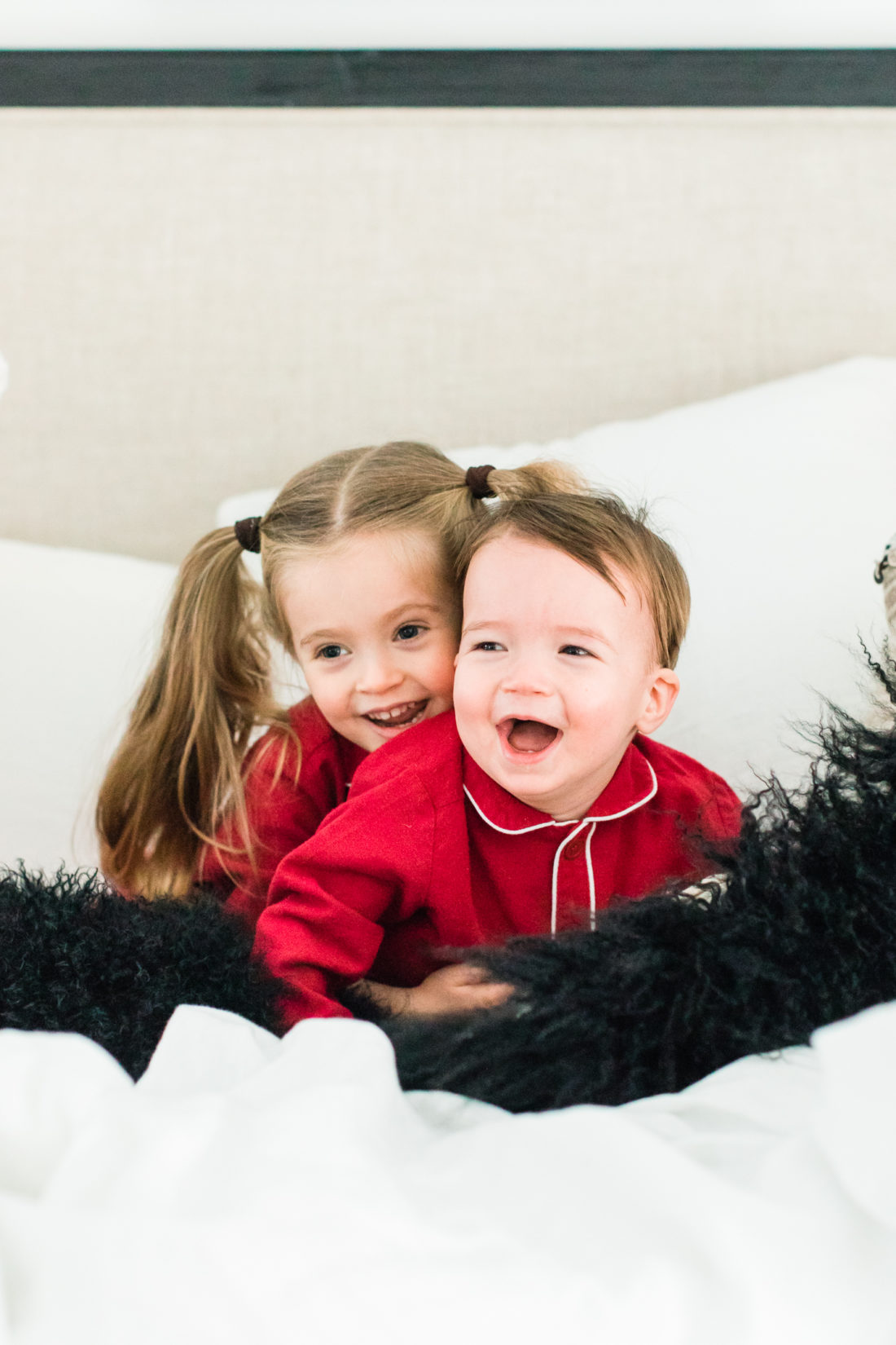 Marlowe Martino laughs and wrestles with little brother Major in the master bedroom of their Connecticut home