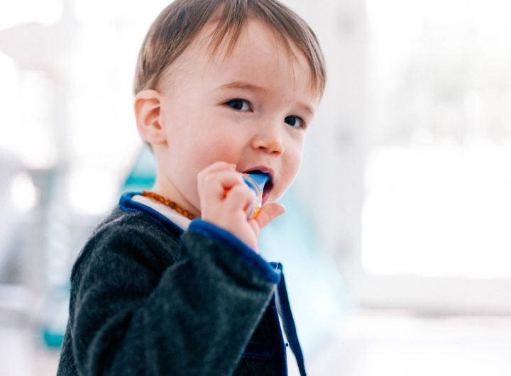 Major Martino wears a grey mohair suit and brushes his few teeth with a baby tooth brush in the family room of his Connecticut home