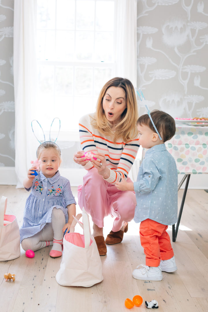 Eva Amurri Martino finding a finger puppet toy inside of a plastic egg during her annual Easter Egg Hunt with her children Marlow and Major