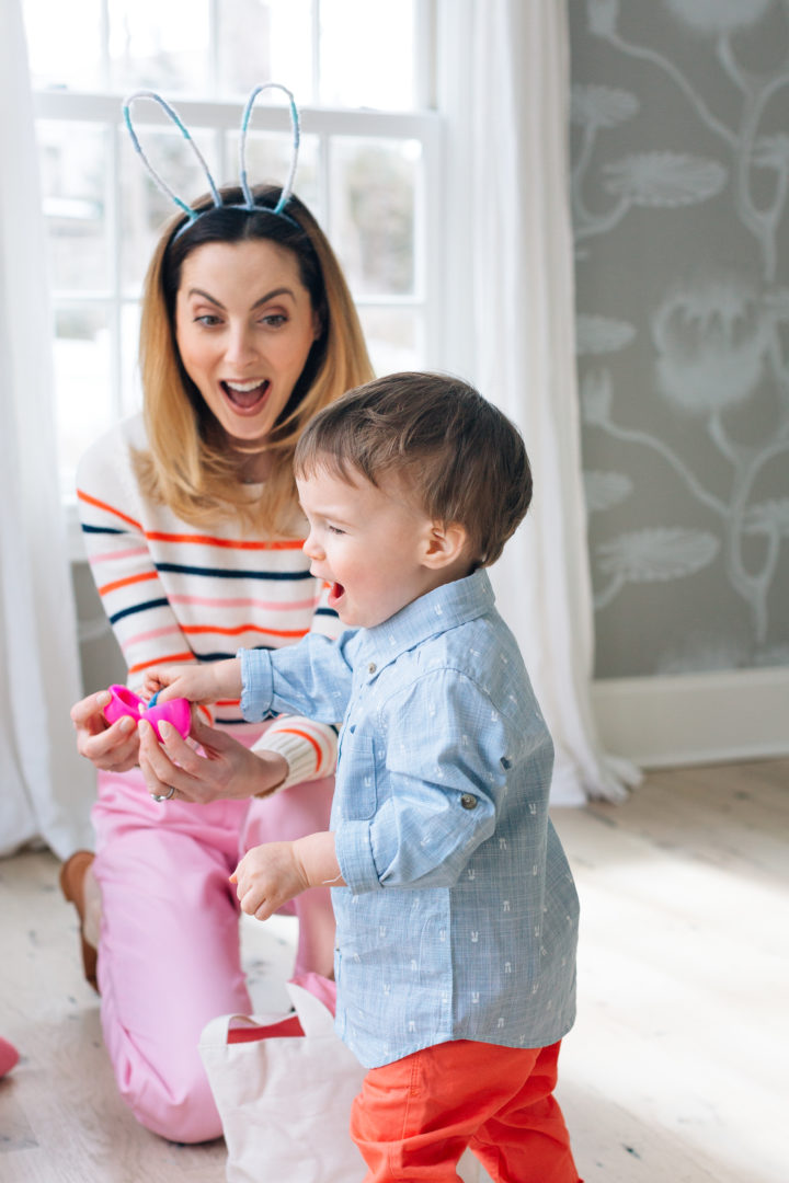 Eva Amurri Martino finding a finger puppet toy inside of a plastic egg during her annual Easter Egg Hunt with her son Major