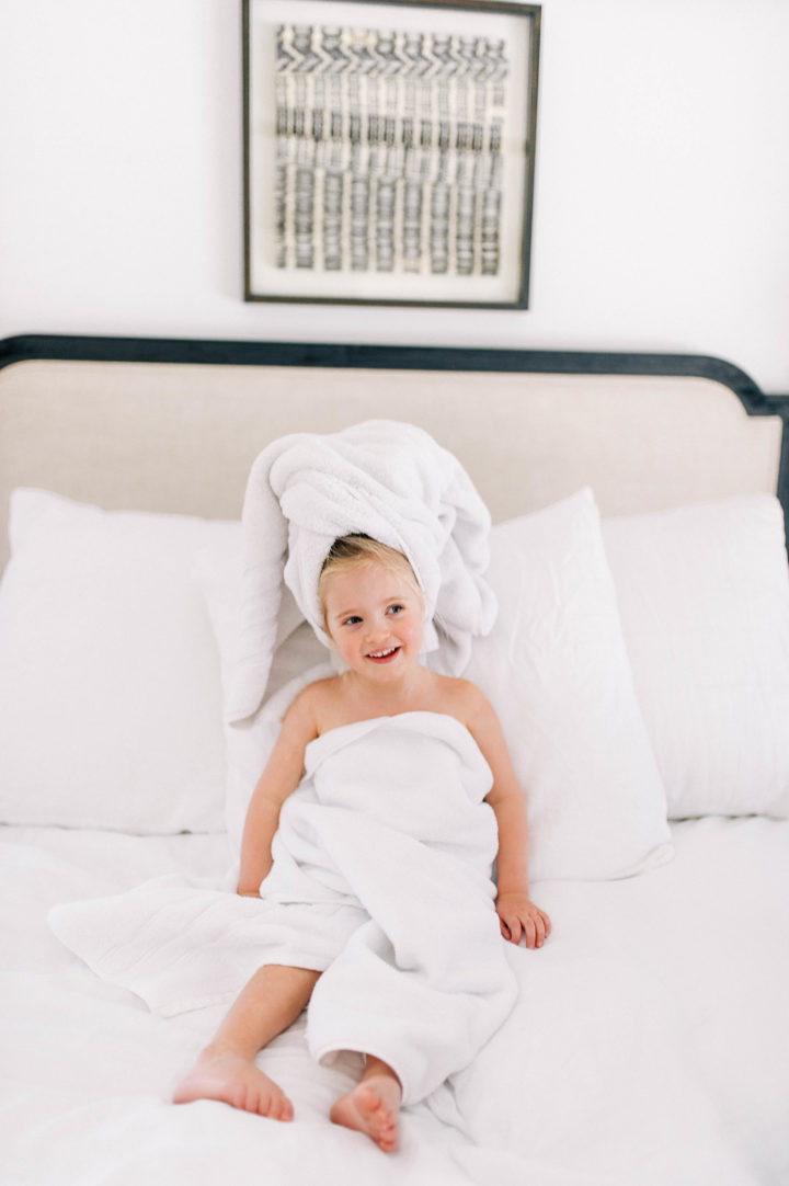 Eva Amurri Martino's daughter Marlowe makes a silly face while she lies in bed with a towel in her hair