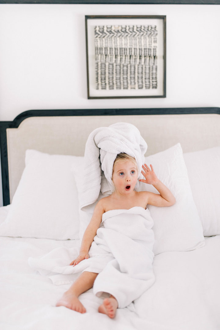 Eva Amurri Martino's daughter Marlowe makes a silly face while she lies in bed with a towel in her hair