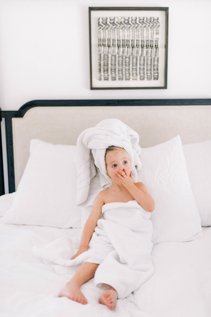 Eva Amurri Martino's daughter Marlowe makes a silly face while she lies in bed with a towel in her hair
