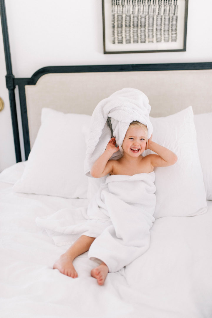 Eva Amurri Martino's daughter Marlowe makes a silly face while she lies in bed with a towel in her hair