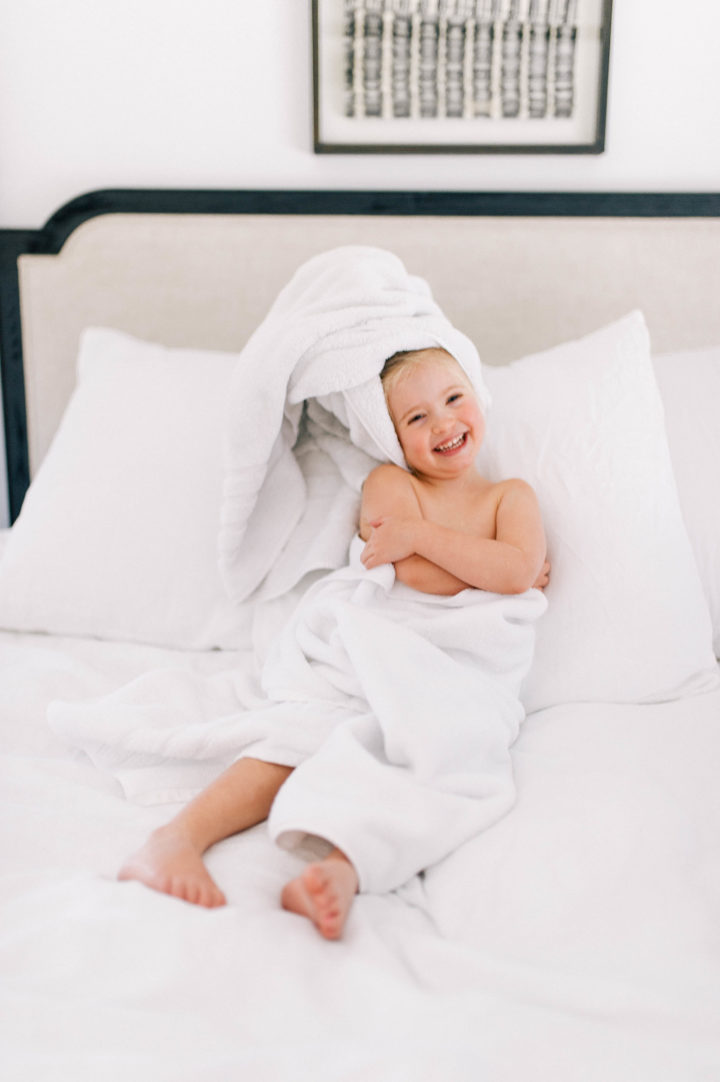 Eva Amurri Martino's daughter Marlowe makes a silly face while she lies in bed with a towel in her hair