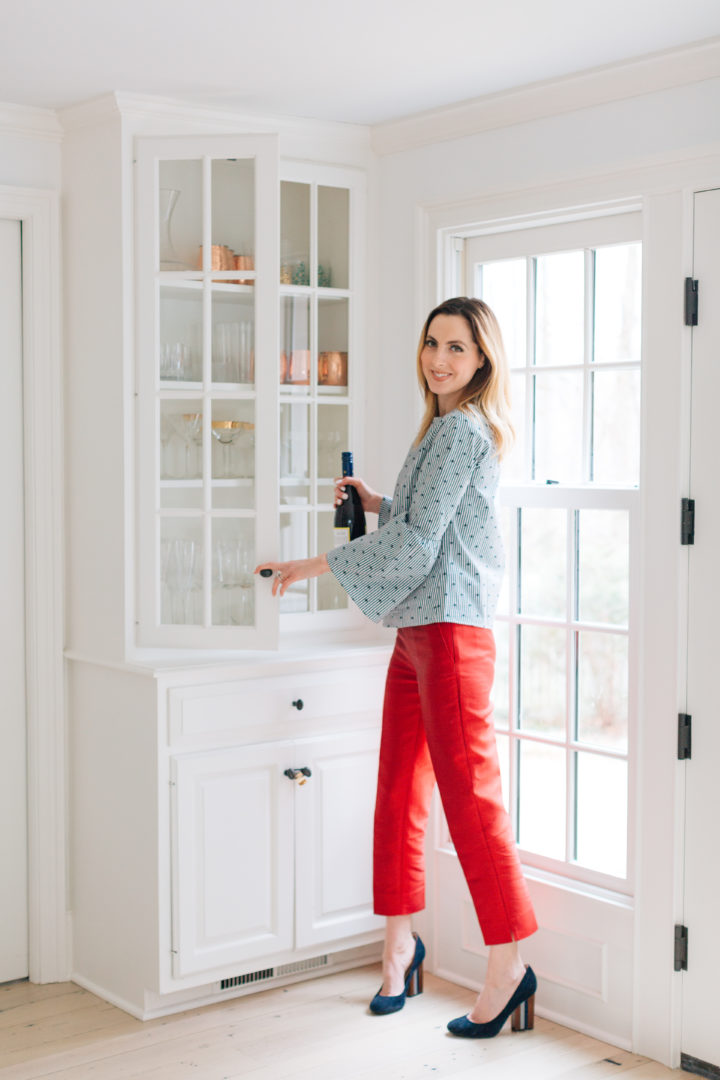 Eva Amurri Martino grabs a bottle of red wine in a blue top at her Connecticut home