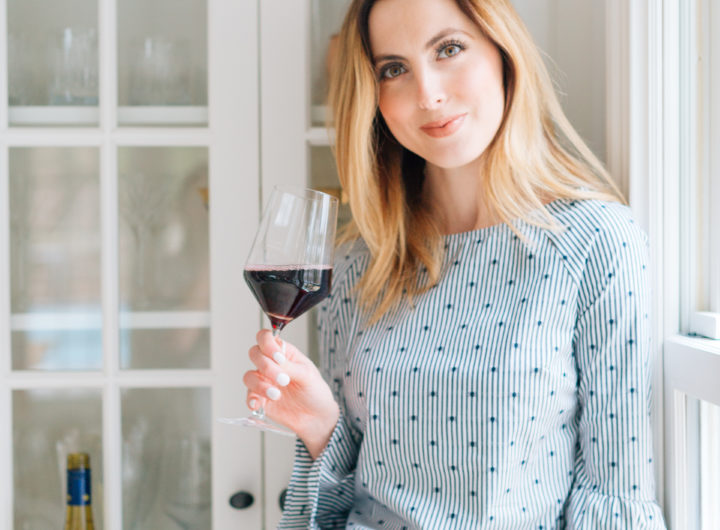 Eva Amurri Martino sips on a glass of red wine in a blue top at her Connecticut home