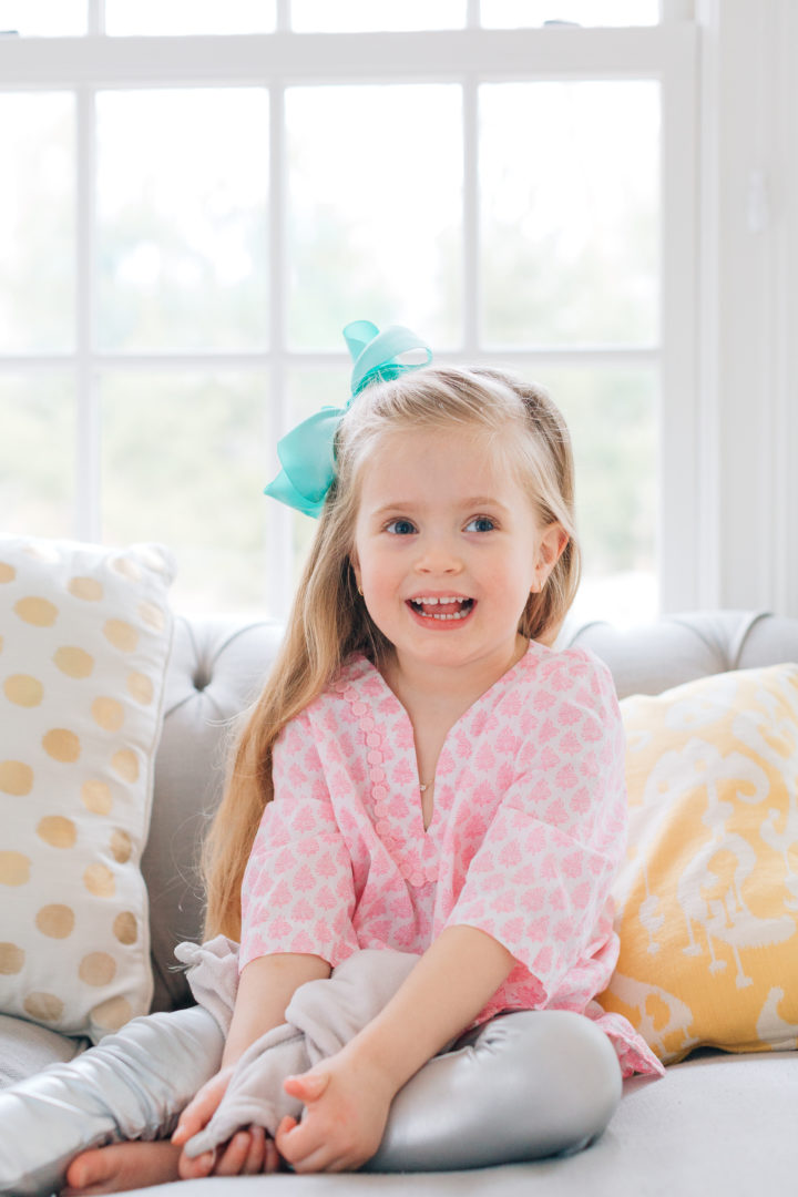 Marlowe Martino shows off her side part with a blue bow in her hair.