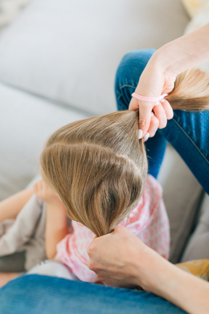 Eva Amurri Martino puts her daughter Marlowe's hair into two twisted knots.