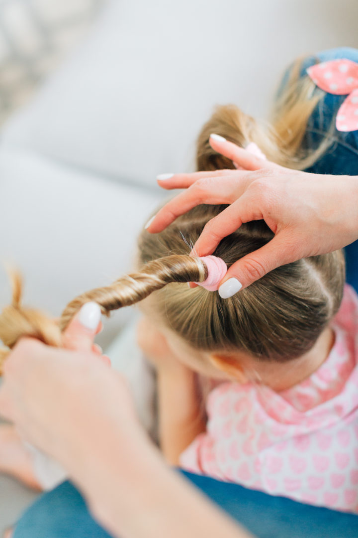 Eva Amurri Martino puts her daughter Marlowe's hair into two twisted knots secured with pink polka dot hairties.