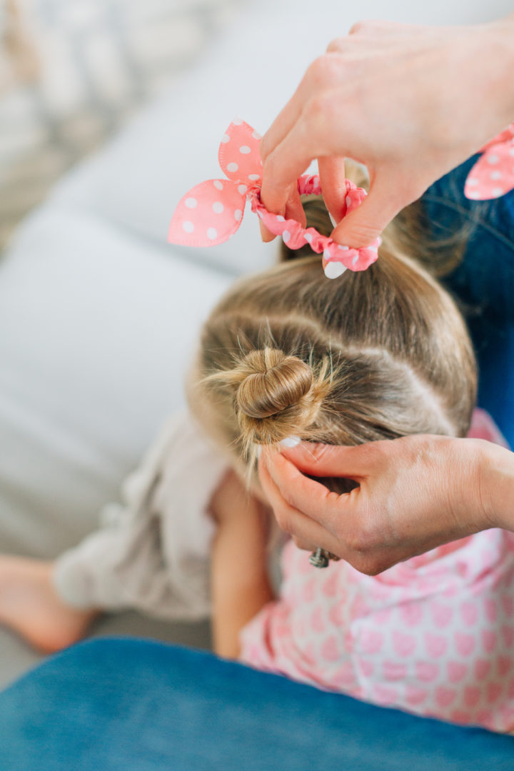 Eva Amurri Martino puts her daughter Marlowe's hair into two twisted knots secured with pink polka dot hairties.