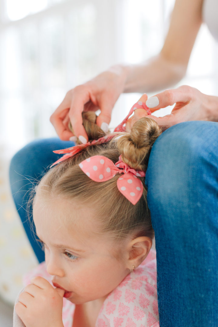 Eva Amurri Martino puts her daughter Marlowe's hair into two twisted knots secured with pink polka dot hairties.