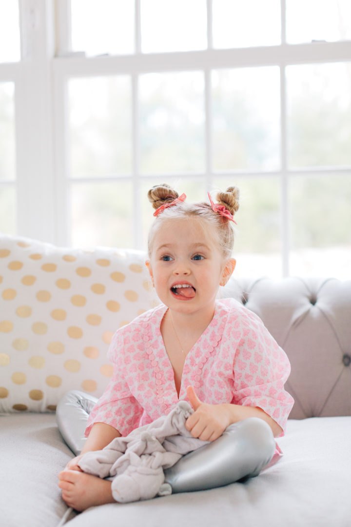 Marlowe Martino shows off her twisted double bun hairstyle on the couch in her Connecticut home.