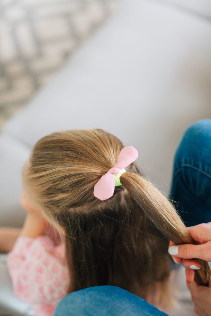 Marlowe Martino shows off her Two Bunch Ponytail secured with pink bows.