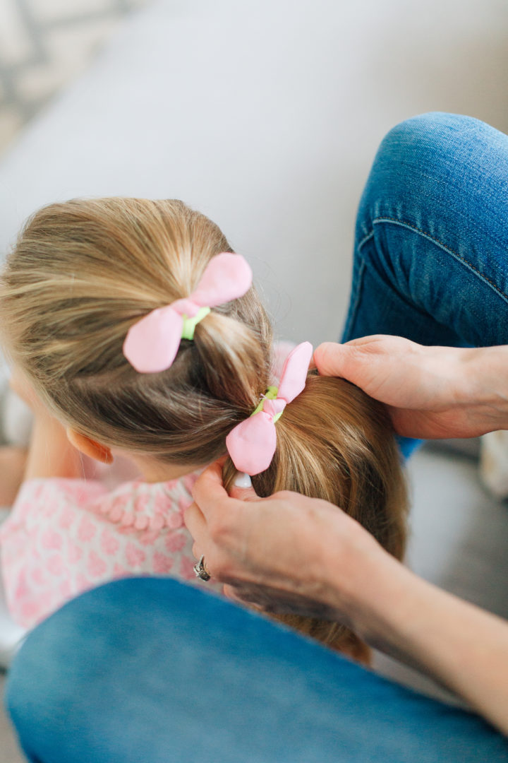 Marlowe Martino shows off her Two Bunch Ponytail secured with pink bows.