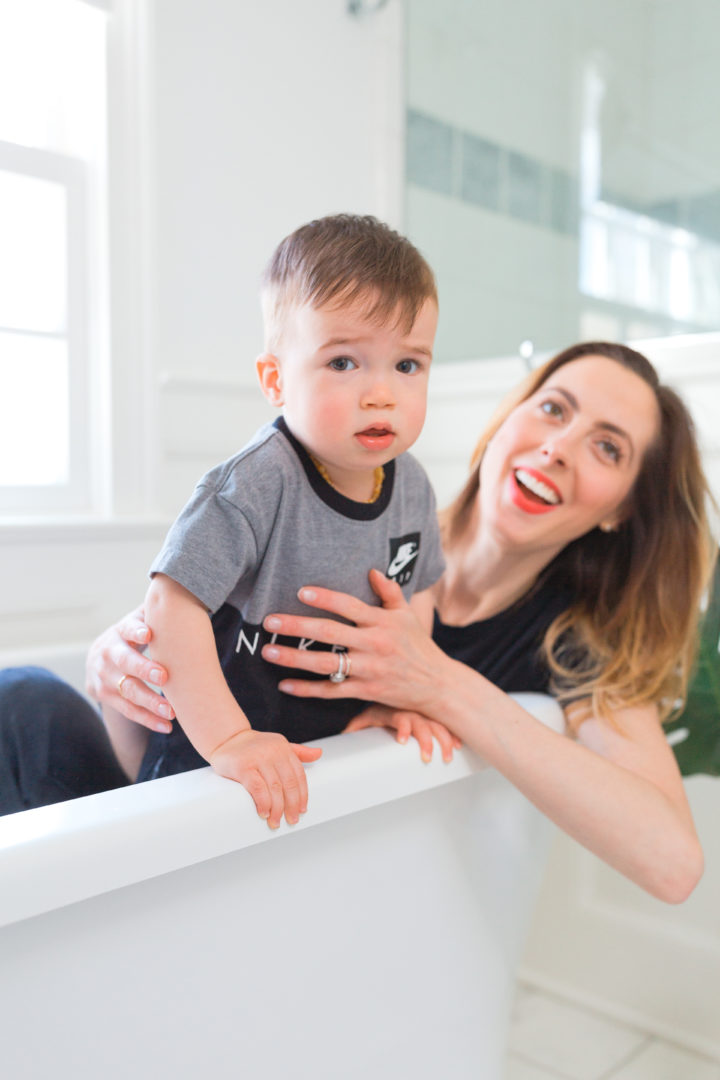 Eva Amurri Martino laughs while she sits in the bathtub with son Major