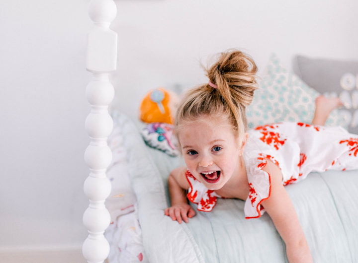 Eva Amurri Martino's daughter Marlowe lies on her bed in a topknot a bright dress