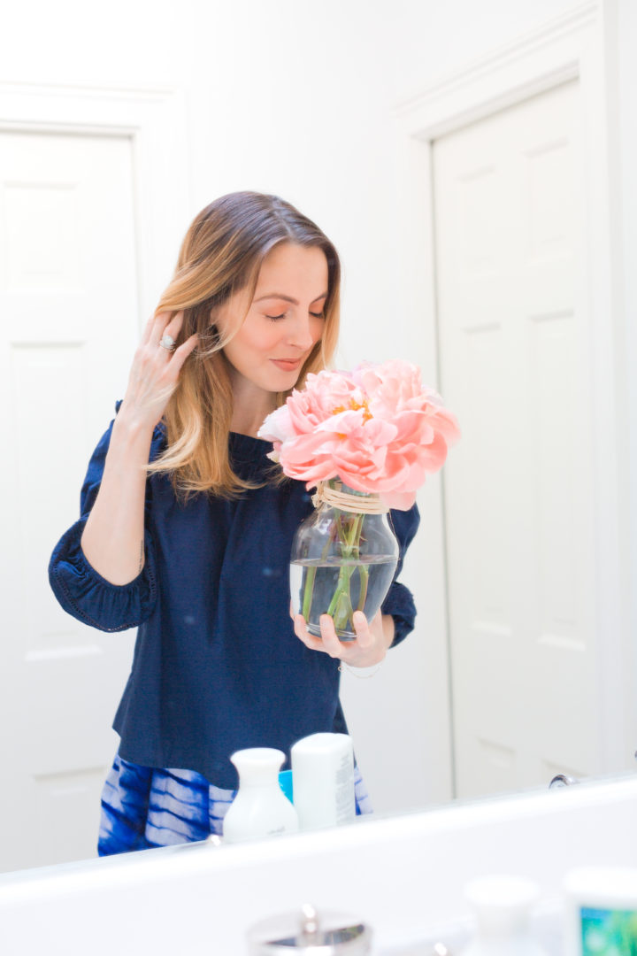 Eva Amurri Martino smells pink peonies in her bathroom