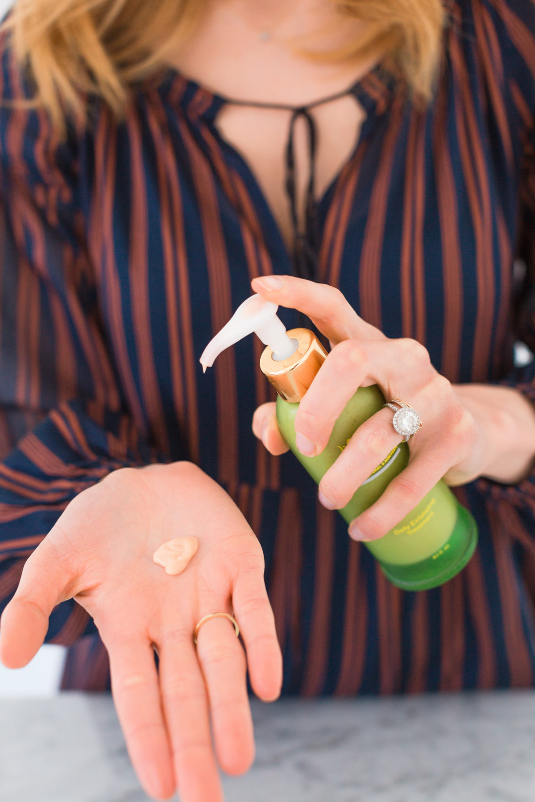 Eva Amurri Martino squirts a little bit of creamy regenerative cleanser in to her palm