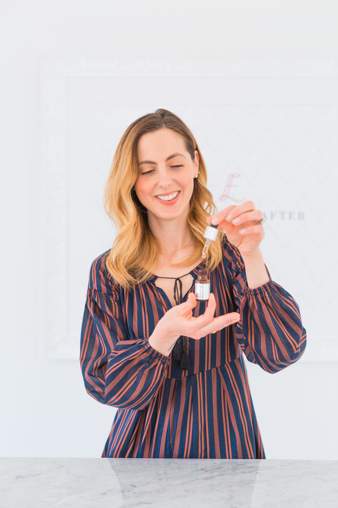 Eva Amurri Martino applies several drops of vitamin c serum to her palms before applying to her face