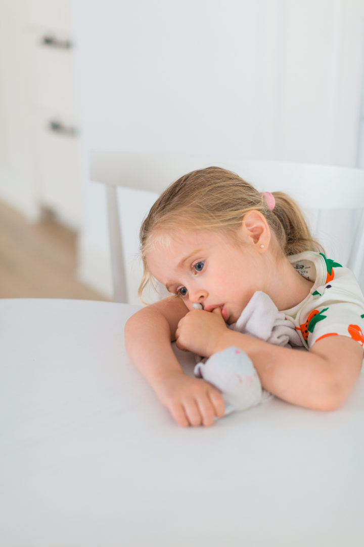 Eva Amurri Martino's daughter Marlowe sucks her thumb and rests her head on the table