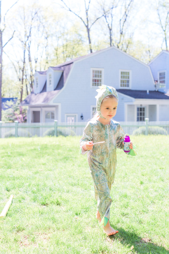 Eva Amurri Martino's daughter Marlowe wars a dinosaur costume and carries bubbles