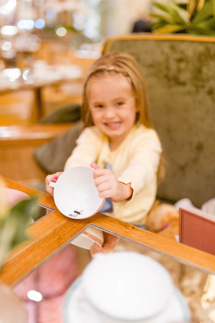 Eva Amurri Martino smiles holding the Eloise tea cup at the Plaza Hotel in New York City